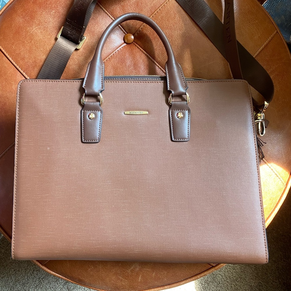 Bostanten covered canvas bag with interior pockets and strap.